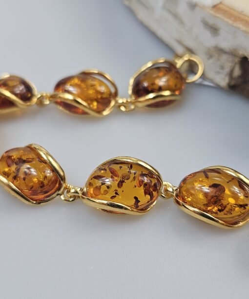Ruda gintarinė paauksuoto sidabro apyrankė